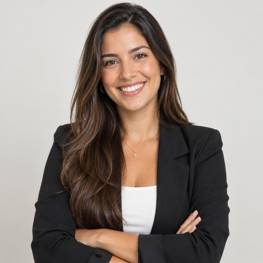Confident Brazilian woman standing with arms crossed, smiling