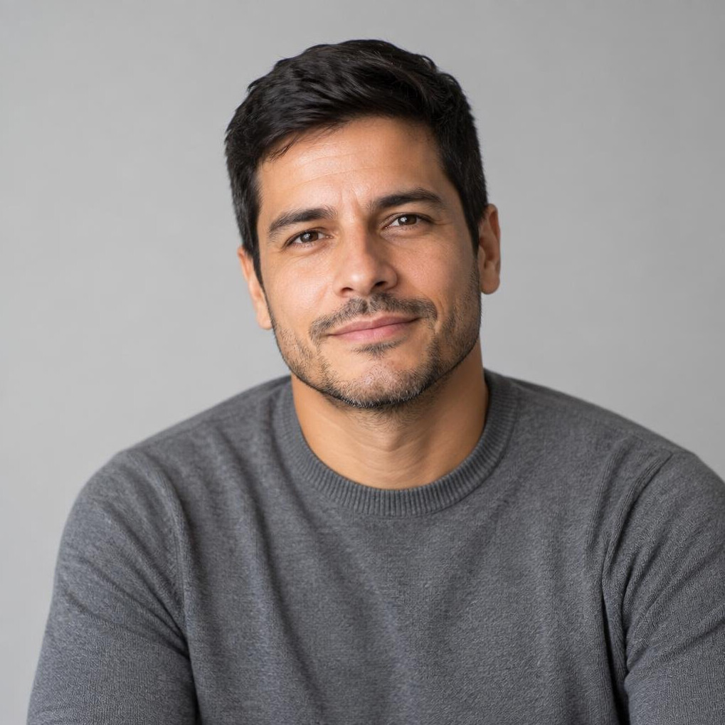 Studio portrait of a Brazilian man in a gray sweater